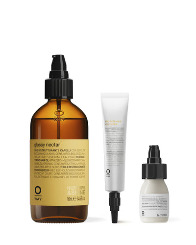 Three hair care products including a brown bottle, white tube, and small white bottle on a white background.